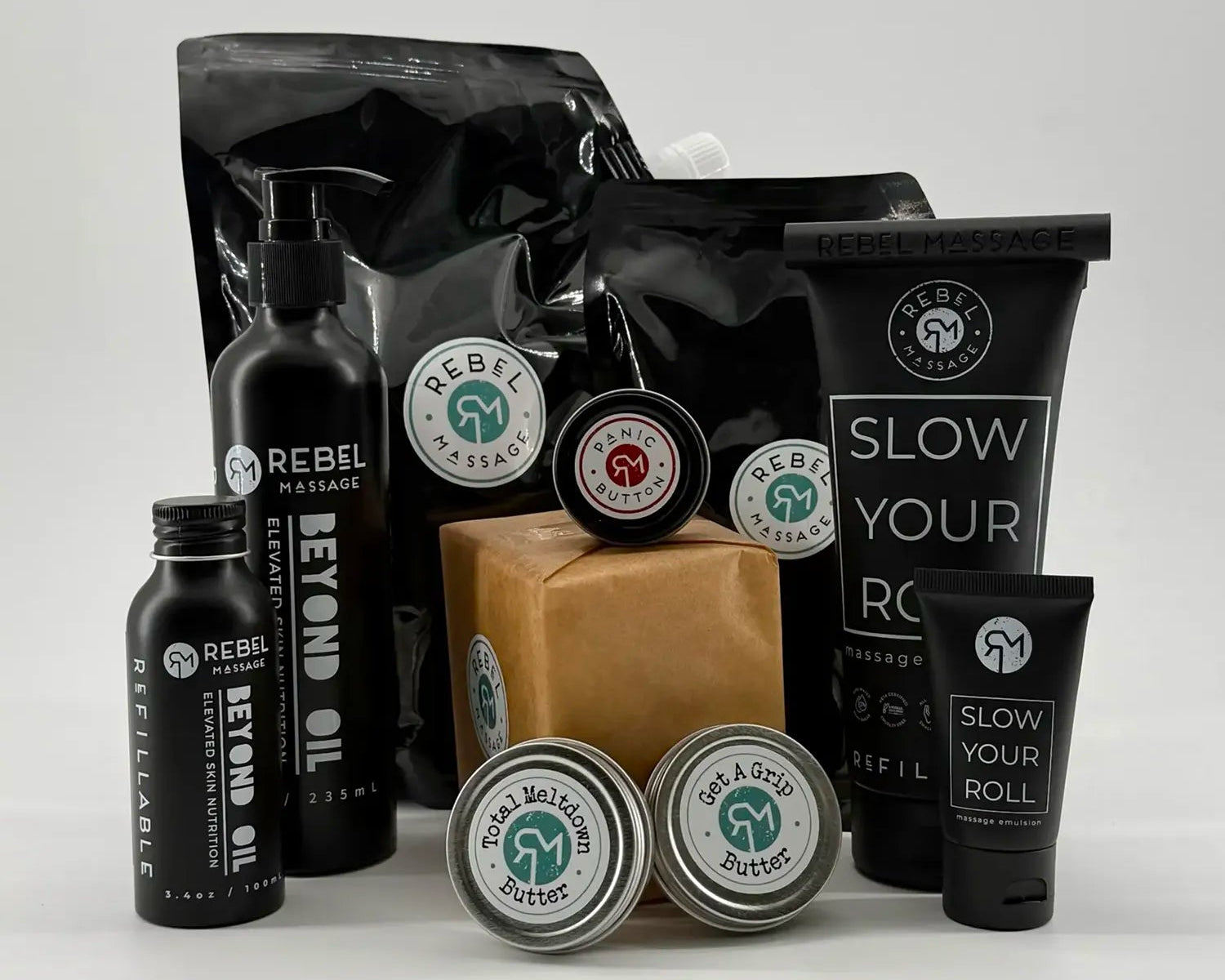 Collection of massage therapy products with visible Rebel Massage branding on a white background